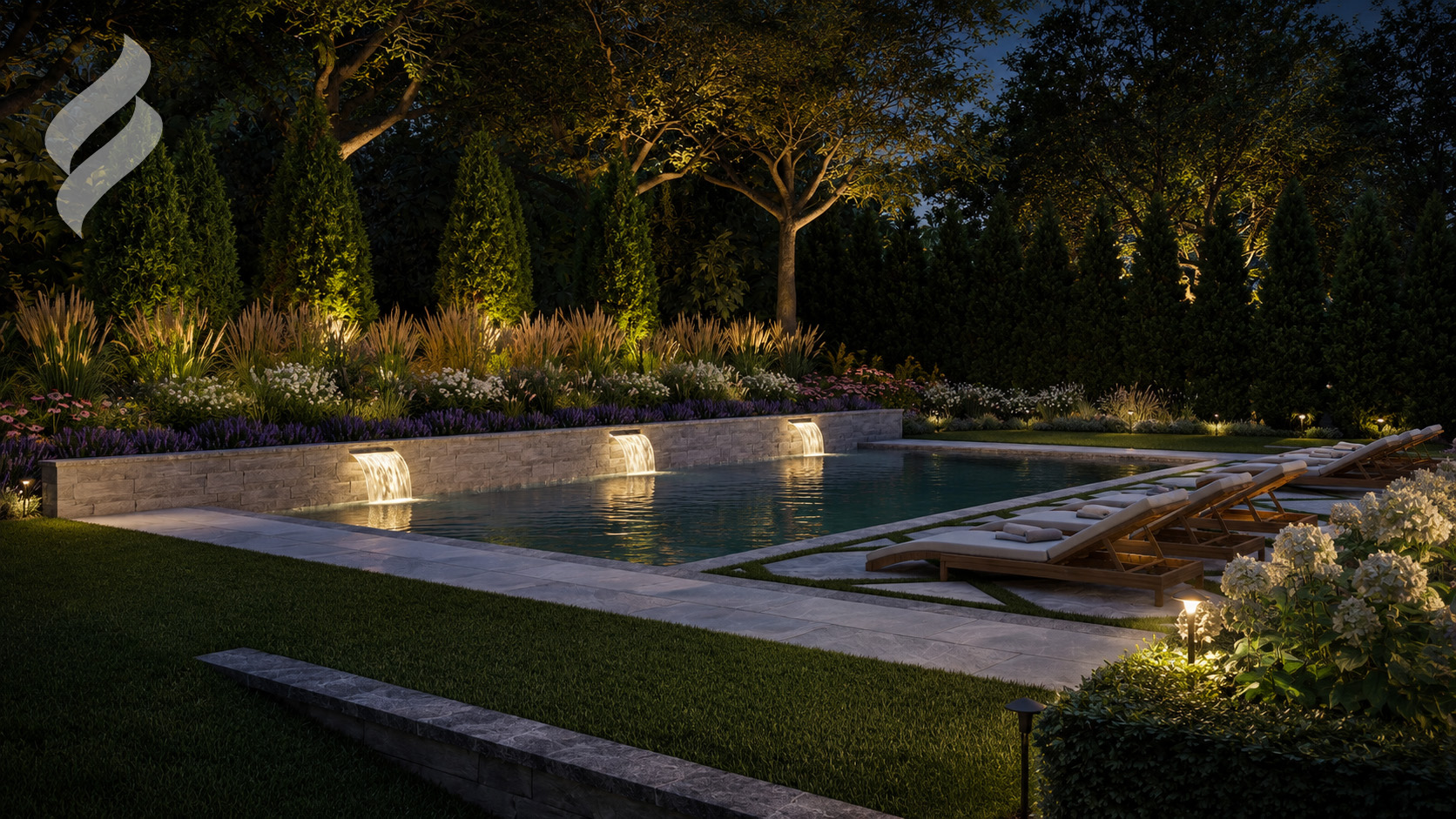 Illuminated pool with stone scupper wall at dusk